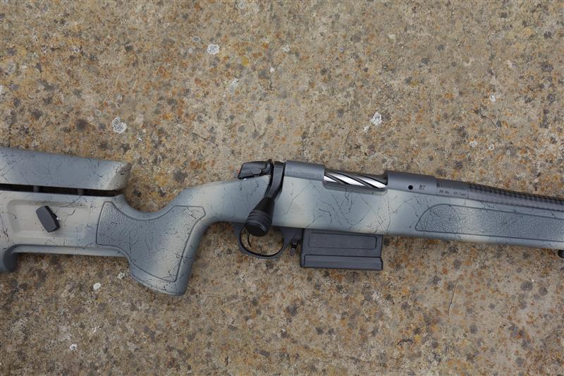 Bergara B14 Wild HMR Carbon rifle with scope, featuring a carbon fiber wrapped barrel, adjustable stock, and muzzle brake, designed for precision shooting.