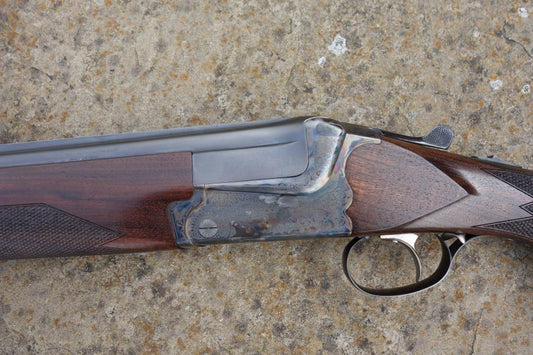 Close-up of a Merkel BDF 2000 Game shotgun, showcasing the single selective trigger and solid game top rib, highlighting its pristine condition and advanced features.