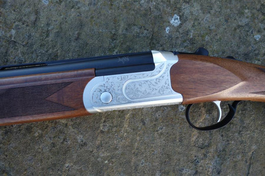 Kofs Sceptre SXE Youth Game, a firearm on a rock, featuring a 13 junior stock, soft rubber butt pad, and single trigger ejector.