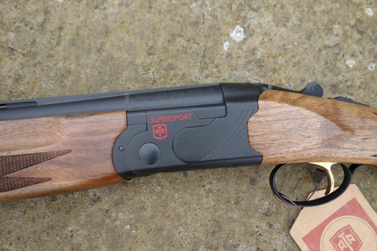 Close-up of ATA Supersport Sporting gun, featuring a detailed view of its matt black action, red accents, and adjustable comb, highlighting its competition-ready design.