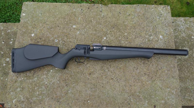 FX DRS Classic Synthetic rifle on stone surface, featuring a sleek, lightweight design with a 16-shot mini magazine, offering impressive performance.