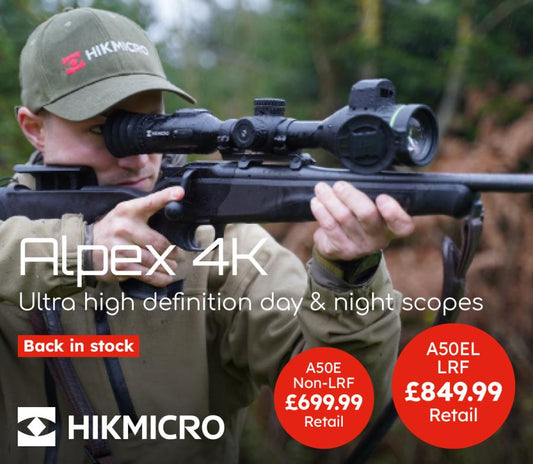 HIKMICRO Alpex HD LRF 4K 3.5-28 Night Vision scope with a man demonstrating aiming, highlighting its advanced rangefinder and night vision capabilities.
