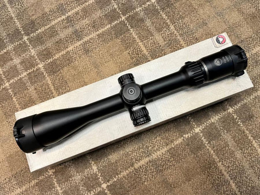 Burris Four Xe Rifle Scope featuring a 6-24 x 50 magnification, illuminated SCR Mil reticule, on a wooden box, emphasizing its side parallax adjustment and 30mm tube.
