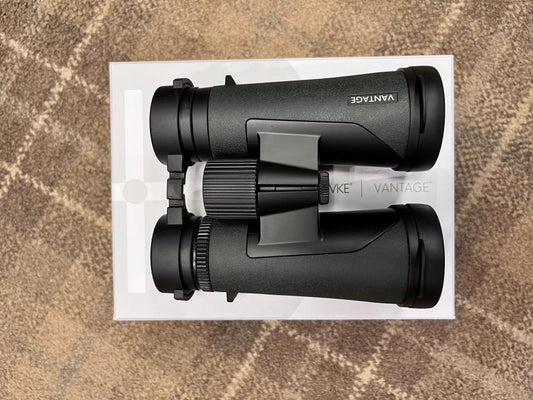 Hawke Vantage 8x42 Binoculars resting on a white box, featuring a durable design and lifetime warranty, ideal for outdoor enthusiasts seeking value and performance.