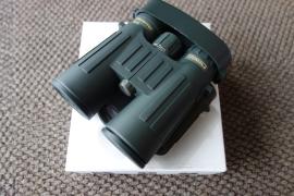 Steiner Observer 8X42 binoculars displayed prominently on a white surface, showcasing their compact design and sturdy build suitable for outdoor observation.