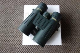 Steiner Observer 10X42 binoculars displayed on a white surface, showcasing a sleek design ideal for detailed outdoor observation.