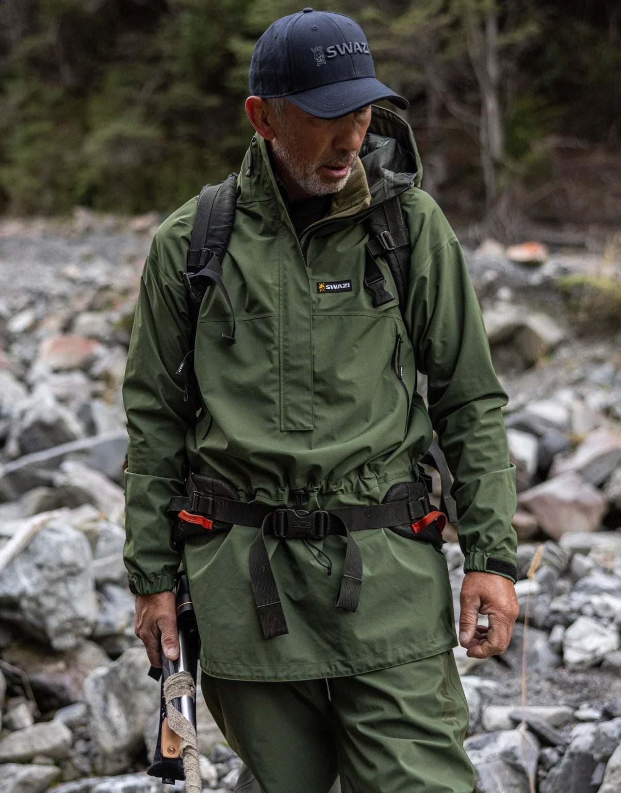 Swazi Tahr Ultralite Jacket | Waterproof Hunting Jacket worn by a man with a hat, highlighting its windproof design and adjustable features for outdoor activities.