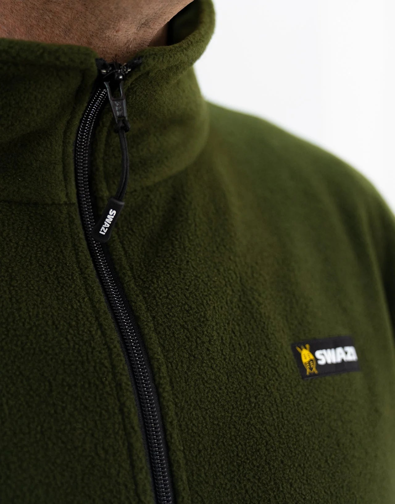 Swazi Doughroaster | Comfortable Fleece Jumper | Olive - Close-up of high-collar green fleece with long chest zipper and kangaroo pocket for versatile use.