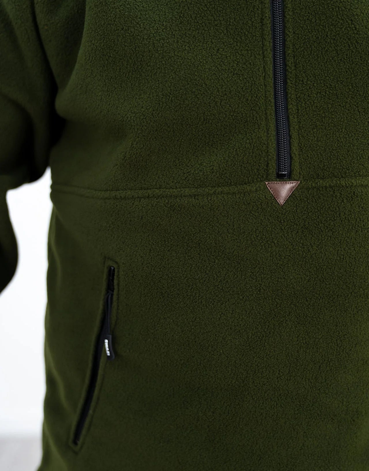 Swazi Doughroaster | Comfortable Fleece Jumper | Olive features a close-up of its long chest zipper and high collar, showcasing its functional design.