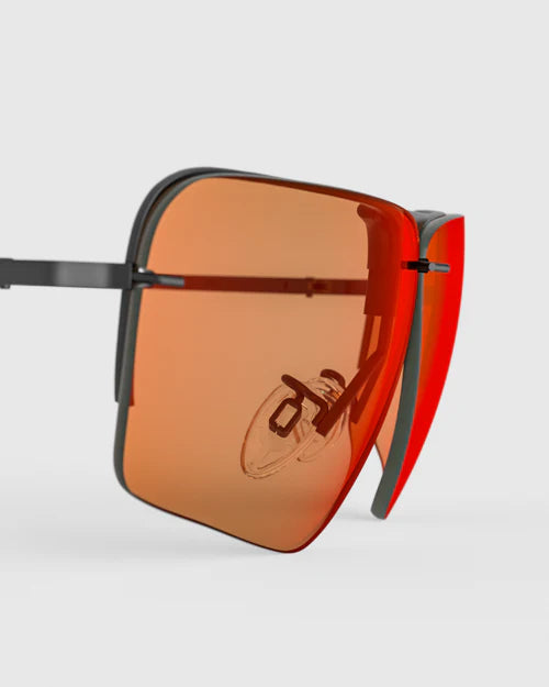Sunglasses with orange lenses, titled Ranger Edge Lens | RIACT A.I & Claysight, showcasing a sleek design suitable for diverse conditions.