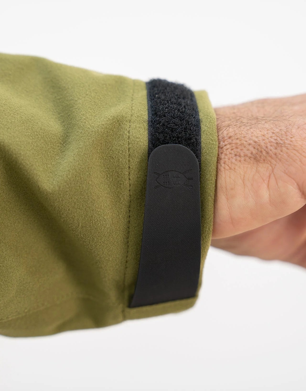 Swazi Kagoule Anorak with adjustable Velcro cuffs, large hand warmer pocket, and hood, showcased on a person, emphasizing its utility and quiet waterproof design.