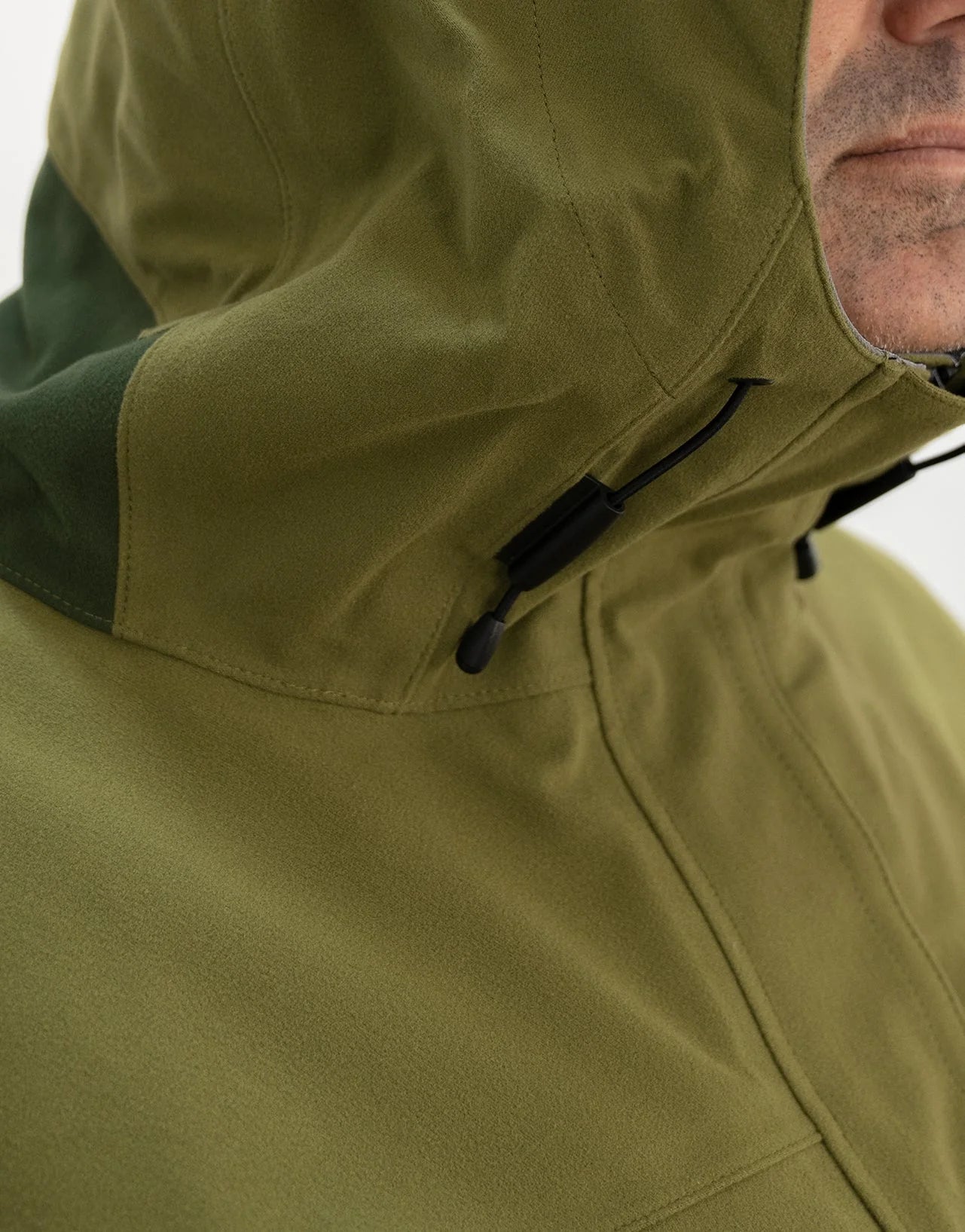 Swazi Kagoule Anorak worn by man, showcasing its water-resistant zips, adjustable hood, and large pockets, designed for quiet, waterproof hunting utility.