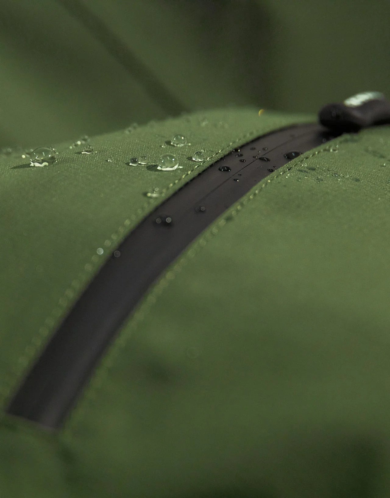 Swazi Tahr Ultralite Jacket showcasing a green waterproof zipper, highlighting the lightweight, waterproof design ideal for hunting and hiking in variable weather conditions.