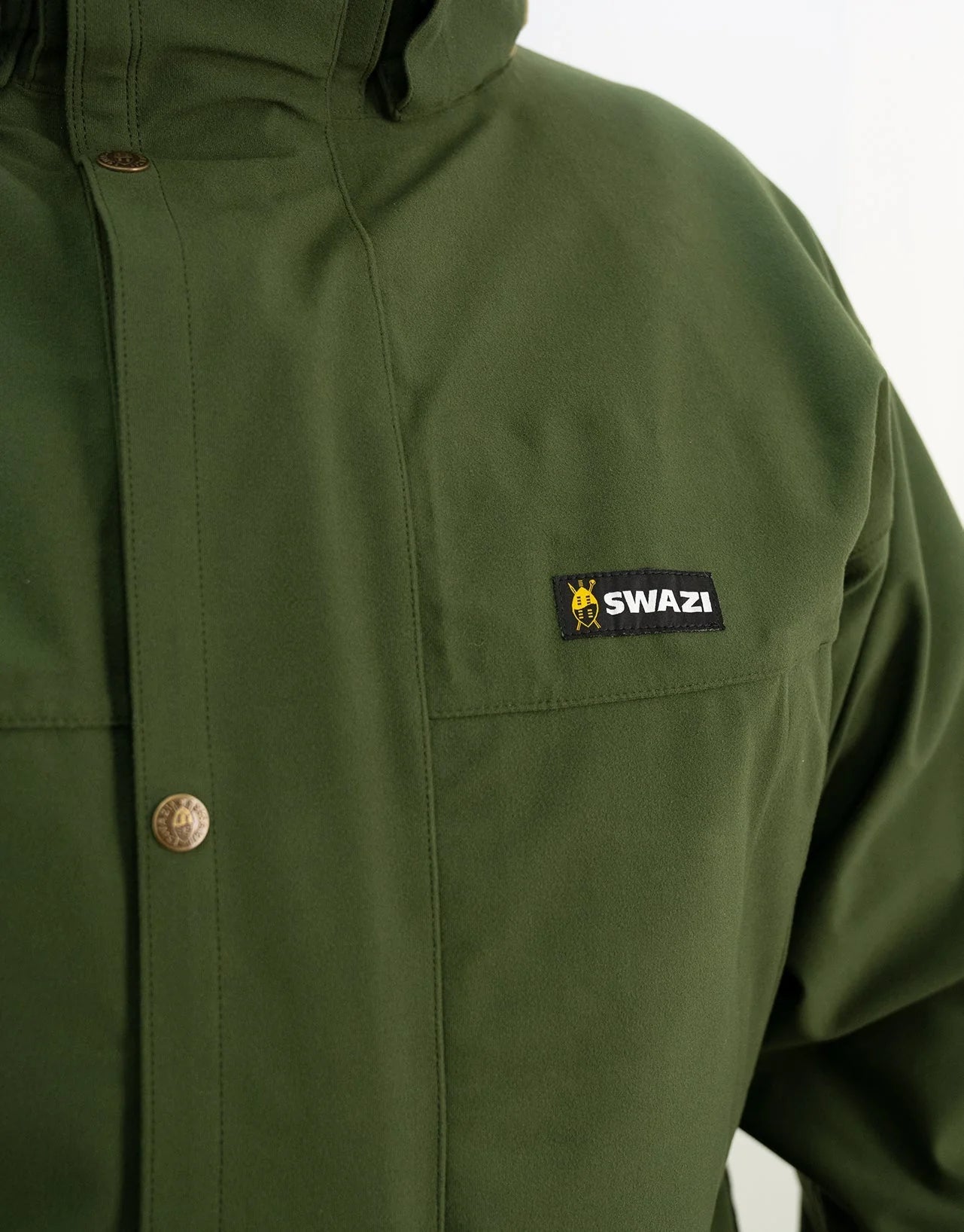 Swazi Wapiti XP Men's Hunting Jacket with visible green fabric, black label, button details; features include waterproof AEGIS fabric, zip-off hood, and multiple pockets.