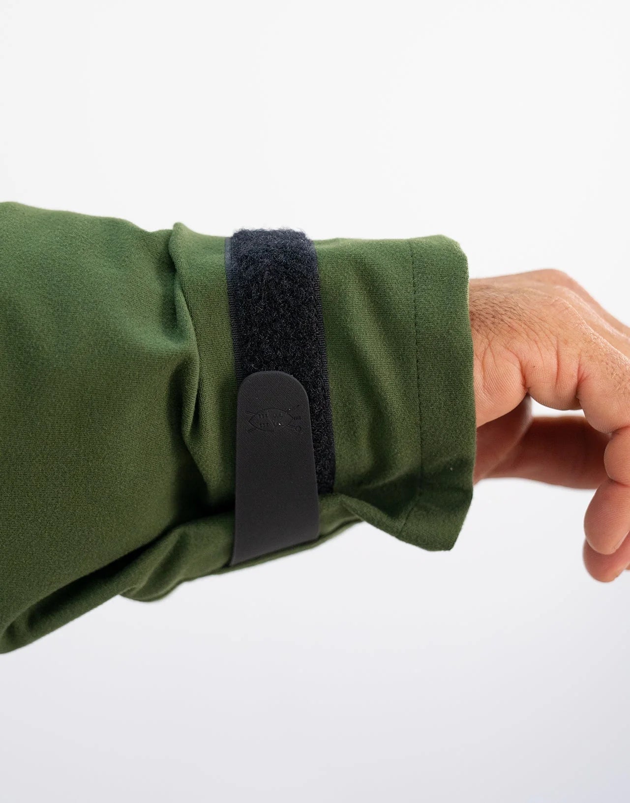 Hand adjusting Velcro strap on Swazi Wapiti XP Men's Hunting Jacket, showcasing its durable, waterproof design, ideal for harsh outdoor conditions.