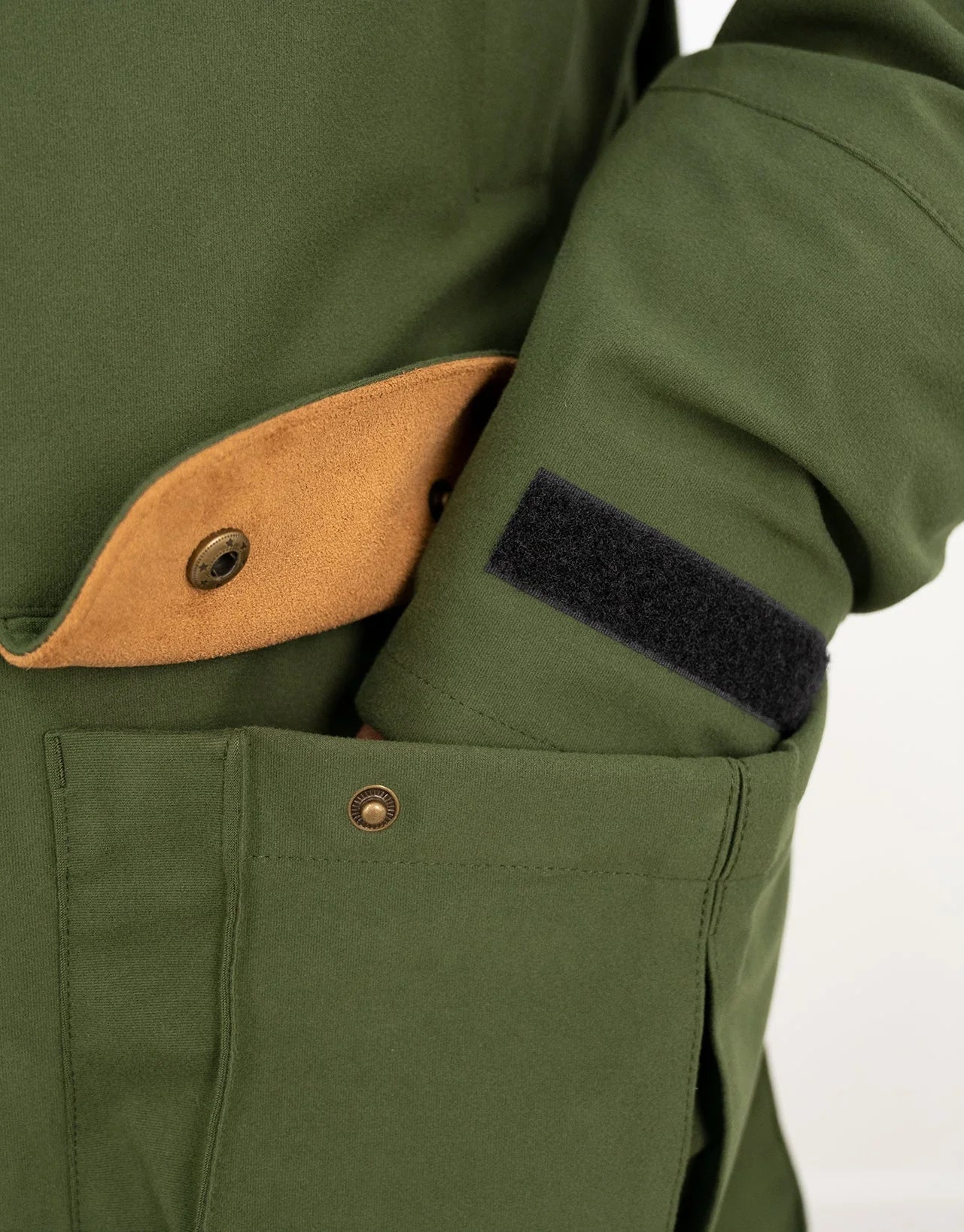 Swazi Wapiti XP Men's Hunting Jacket close-up, showcasing button and pocket details, emphasizing durable, quiet, waterproof fabric ideal for outdoor activities.