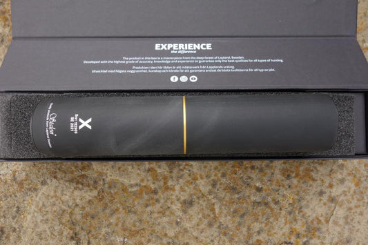 Stalon X108 suppressor with over barrel design, featuring a sleek cylindrical shape on a marbled surface, emphasizing easy maintenance and compatibility.