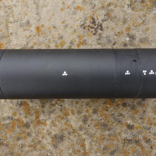 Schultz & Larsen Venom cylinder, featuring a 14x1mm thread, optimized for sound reduction and minimal recoil, displayed on a stone surface.