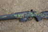 Tikka T3X CTR Camo rifle on concrete, featuring a scandi camo stock, heavy barrel, detachable magazine, and picatinny rail for versatile use.