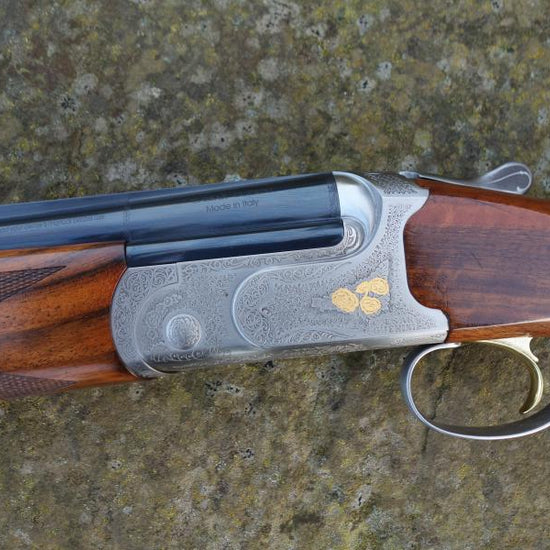 Close-up of Caesar Guerini Tempio Game gun, showing its well-figured stock, rounded pistol grip, and visible trigger, highlighting superb condition and craftsmanship.