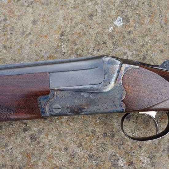 Close-up of a Merkel BDF 2000 Game shotgun, showcasing the single selective trigger and solid game top rib, highlighting its pristine condition and advanced features.