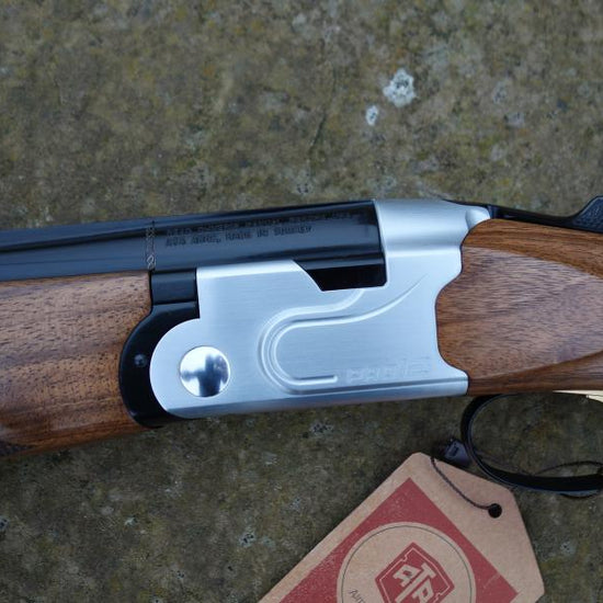 ATA Pro 12 Competition Sporting gun, close-up showing the adjustable comb, palm swell grip, and trap style forend with finger groove.