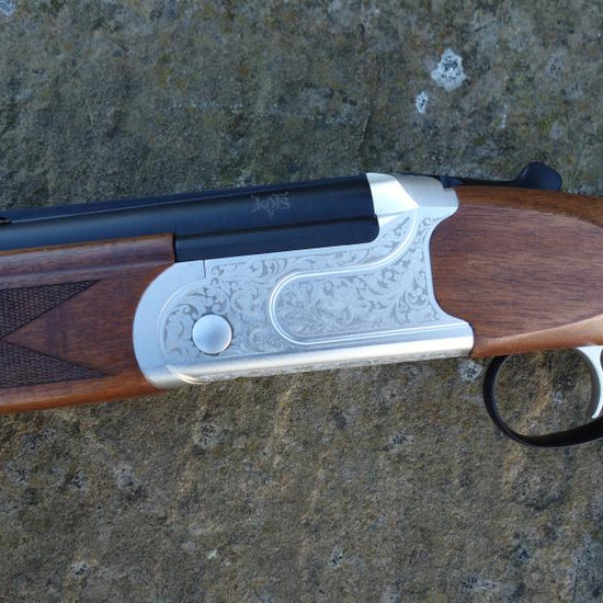 Kofs Sceptre SXE Youth Game, a firearm on a rock, featuring a 13 junior stock, soft rubber butt pad, and single trigger ejector.