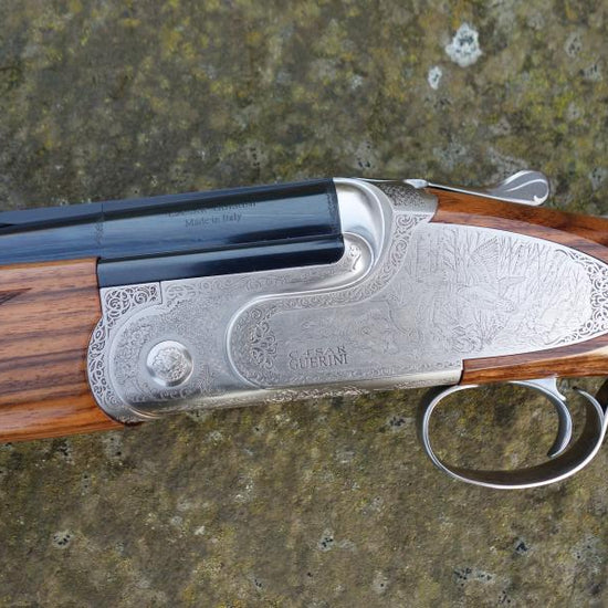 Close-up of a Caesar Guerini Magnus Light Deluxe Game shotgun, showcasing its trigger and barrel details, with a deluxe stock and forend, highlighting its lightweight design.