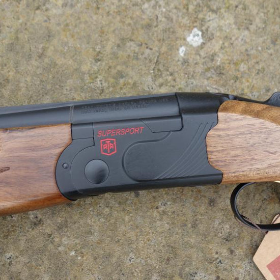 Close-up of ATA Supersport Sporting gun, featuring a detailed view of its matt black action, red accents, and adjustable comb, highlighting its competition-ready design.