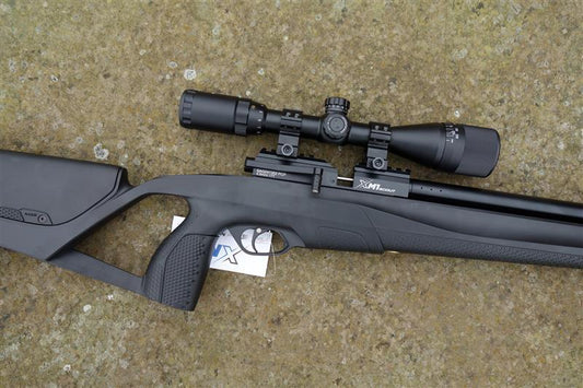 Stoeger XM1 Scout rifle with a scope, featuring side lever cocking and five 10-shot magazines, ideal for precise shooting.