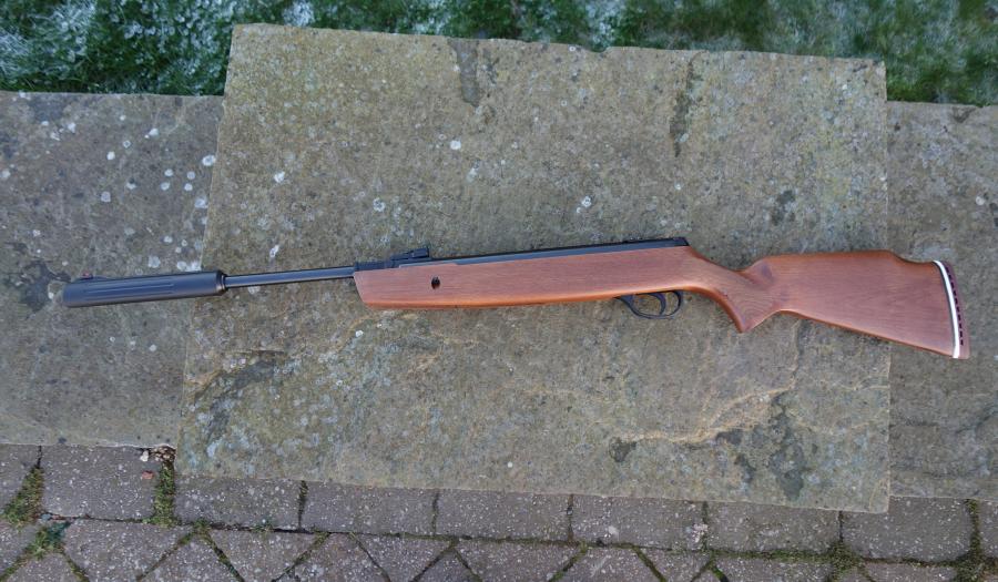 Hatsan 900X Breaker on stone surface, showcasing its springer design with hi-viz open sights and scope rail, ideal for target or small vermin shooting.