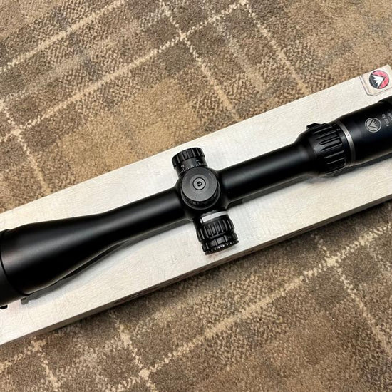 Burris Four Xe Rifle Scope featuring a 6-24 x 50 magnification, illuminated SCR Mil reticule, on a wooden box, emphasizing its side parallax adjustment and 30mm tube.