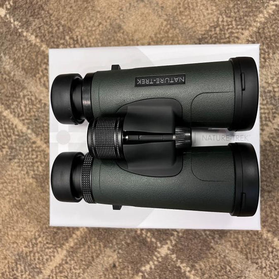 Hawke Nature-Trek 8x42 Binoculars on a white box, showcasing black lenses and optical precision, known for outstanding clarity and lifetime warranty.