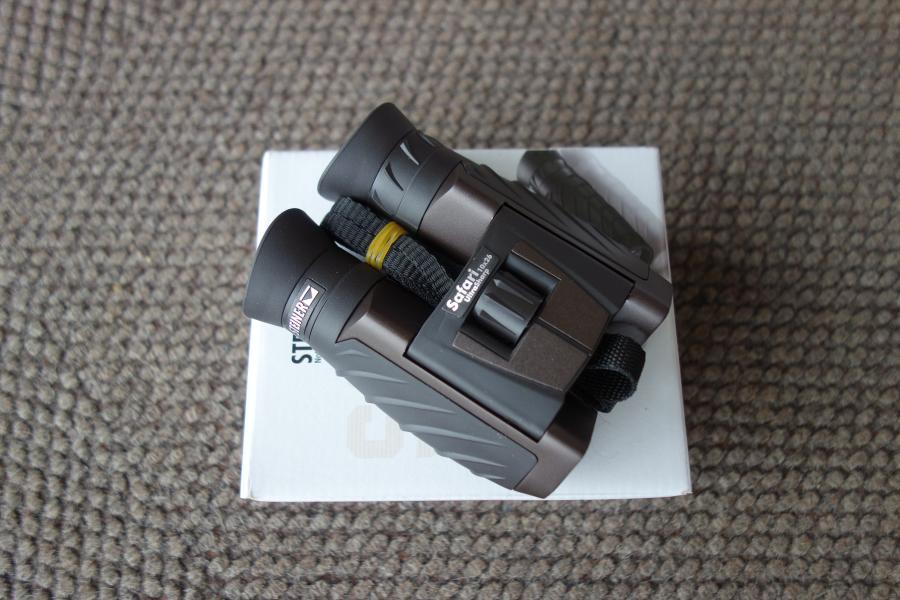 Steiner Safari Ultrasharp 10X26 Binoculars with a black strap, displayed on a white box, ideal for detailed viewing and outdoor adventures.