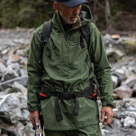 Swazi Tahr Ultralite Jacket | Waterproof Hunting Jacket worn by a man with a hat, highlighting its windproof design and adjustable features for outdoor activities.
