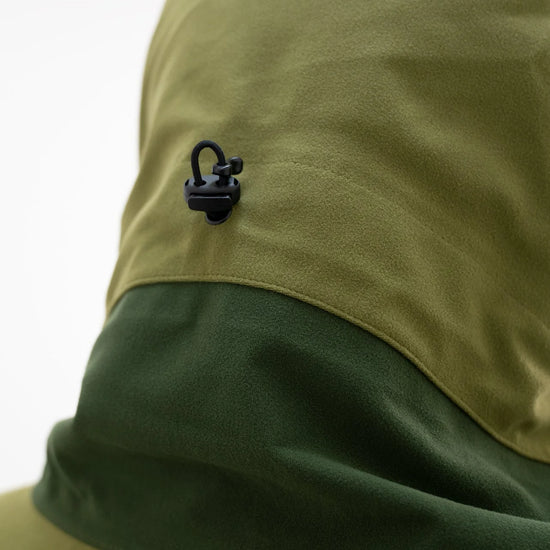 Swazi Kagoule Anorak features a high vision hood with an adjustable cord, black lock, and green fabric, ideal for waterproof hunting.