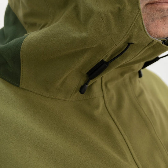 Swazi Kagoule Anorak worn by man, showcasing its water-resistant zips, adjustable hood, and large pockets, designed for quiet, waterproof hunting utility.