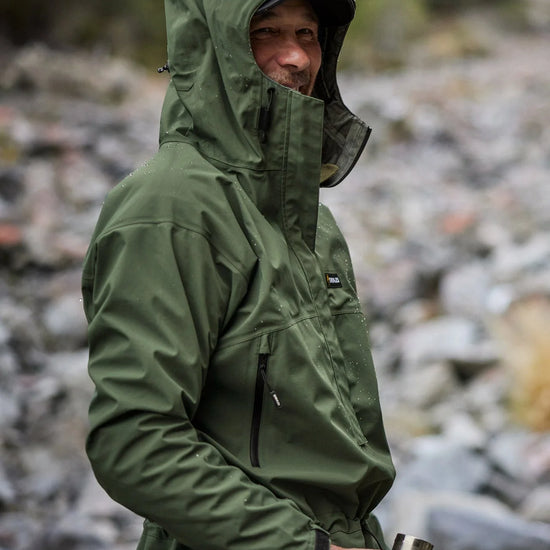 Swazi Tahr Ultralite Jacket showcased on a man outdoors, highlighting its hood and chest pockets, ideal for waterproof, breathable hunting or hiking.