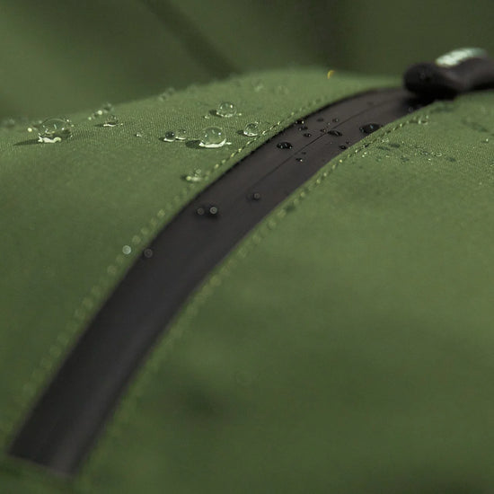 Swazi Tahr Ultralite Jacket showcasing a green waterproof zipper, highlighting the lightweight, waterproof design ideal for hunting and hiking in variable weather conditions.