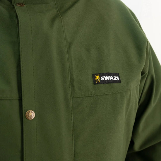 Swazi Wapiti XP Men's Hunting Jacket with visible green fabric, black label, button details; features include waterproof AEGIS fabric, zip-off hood, and multiple pockets.