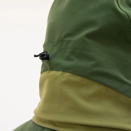 Swazi Wapiti XP Men's Hunting Jacket with zip-off hood, adjustable peak, and waterproof fabric, shown in close-up on a person wearing it.