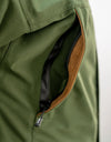 Swazi Wapiti XP Men's Hunting Jacket features close-up of water-resistant zipper and pocket, showcasing durable design for extreme weather conditions.