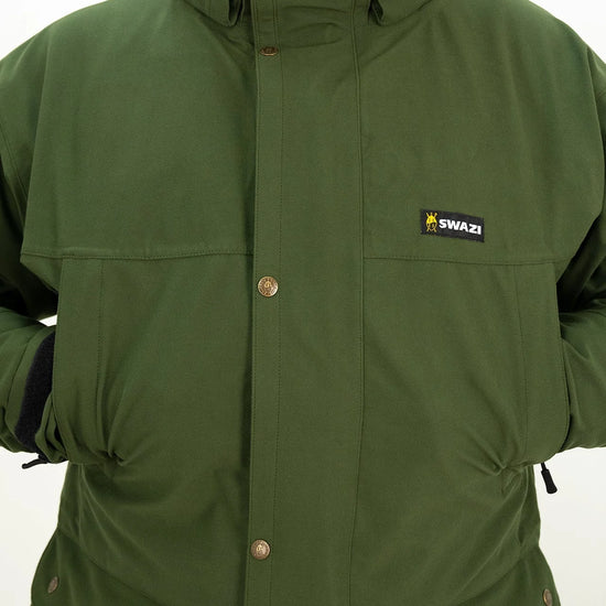 Swazi Wapiti XP Men's Hunting Jacket showcased on a person, highlighting its green fabric, button details, and durable design features like a zip-off hood and water-resistant zippers.